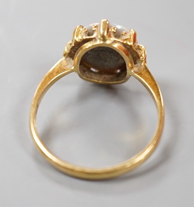 A modern 18ct gold and oval black opal set ring, size P/Q, gross weight 3.6 grams.